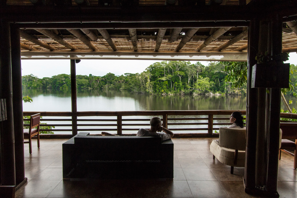 Kayakers relaxing on the deck of La Selva Lodge at the end of a day paddling Amazon rivers