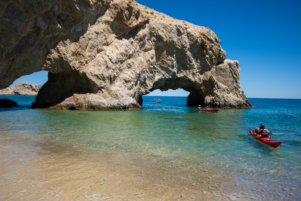 Kayak group paddling through arch Isla San Jose Baja