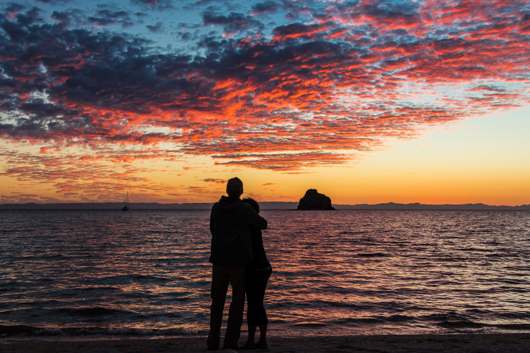 Couple on a Baja kayaking tour share a sunset moment