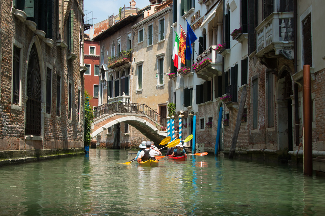 Exploring the Venice canals by kayak.