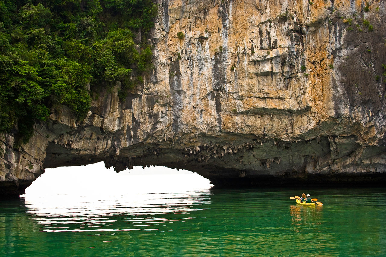 Kayakers Approaching Sea Arch, Kayaking Halong Bay, Vietnam
